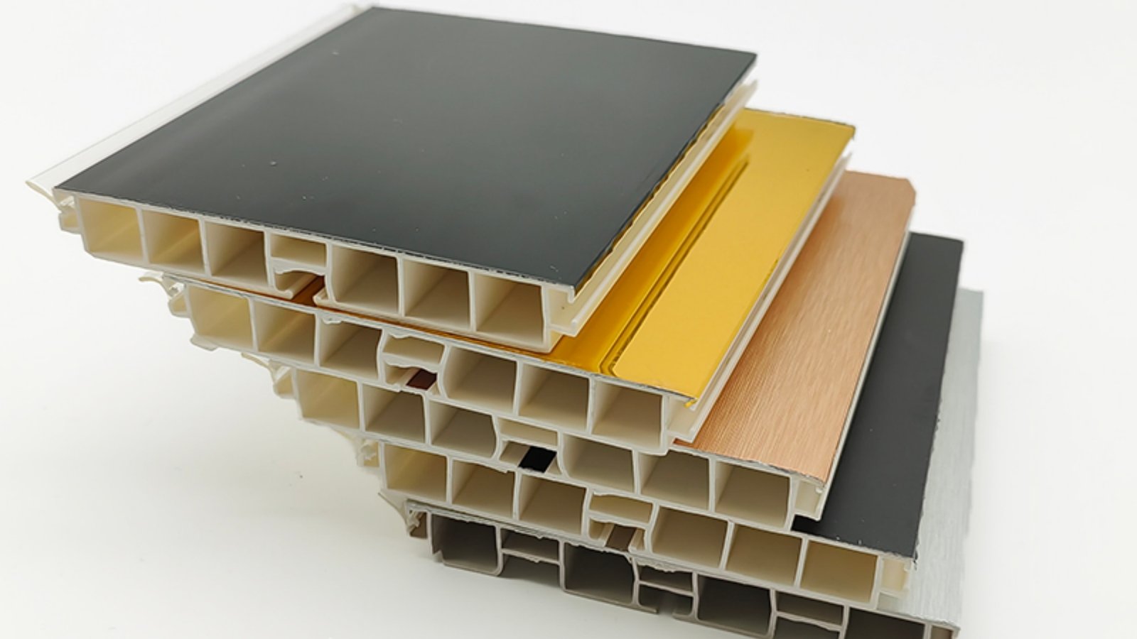 Multi-finish PVC skirting board cross-sections in black, gold, wood grain and silver